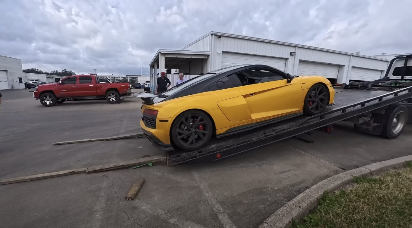 High-end sports car being safely transported on flatbed tow truck